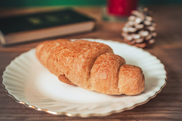 Fresh homemade croissant on wooden table