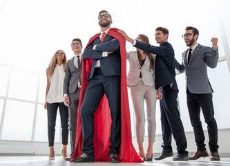 boss is a superhero and the business team is standing together