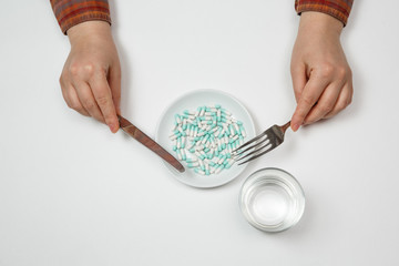 Supplementary food on the dish with fork and spoon