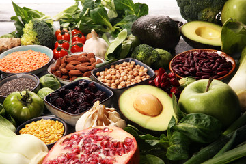 Healthy food clean eating selection. fruit, vegetable, seeds, superfood, cereals, leaf vegetable on rustic background