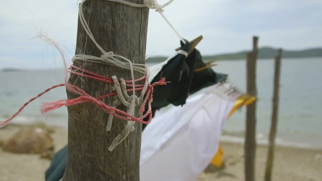 Extreme close-up shot of clothes  hang on a string tied to a wooden pole , Koki stilt village, Port Moresby