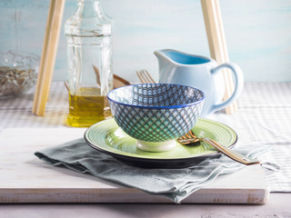 Table setting with an empty bowl on white board