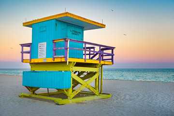 Famous lifeguard tower at South Beach in Miami with a beautiful sunset sky - Powered by Adobe
