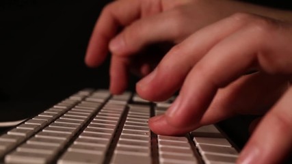 Typing on an old Apple keyboard with smooth forwarding movement.