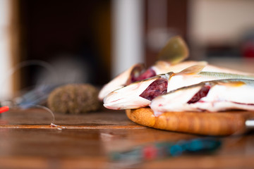 The catch of fresh sea fish lies on a cutting Board on a wooden table in the kitchen Selective...