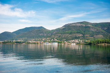 Obraz premium lake in mountains with reflections of city Tivat