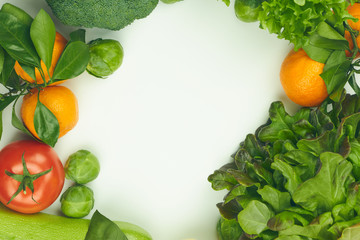 Group of fresh vegetables and lettuce on white background. there is space for text in the center. copy space. vertical view. healthy food.