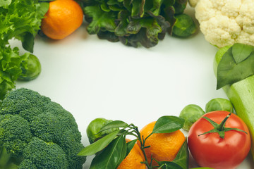 Group of fresh vegetables and lettuce on white background. there is space for text in the center. copy space. vertical view. healthy food.