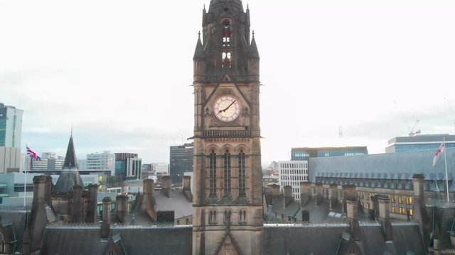 4K Drone aerial shot flying over Manchester Christmas Markets during the early cold mornings Albert Square Town Hall and above Zippy Santa Claus Statue Panning down while flying up
