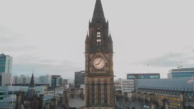4K Drone aerial shot flying over Manchester Christmas Markets during the early cold mornings Albert Square Town Hall and above Zippy Santa Claus Statue Panning downwards while flying up.