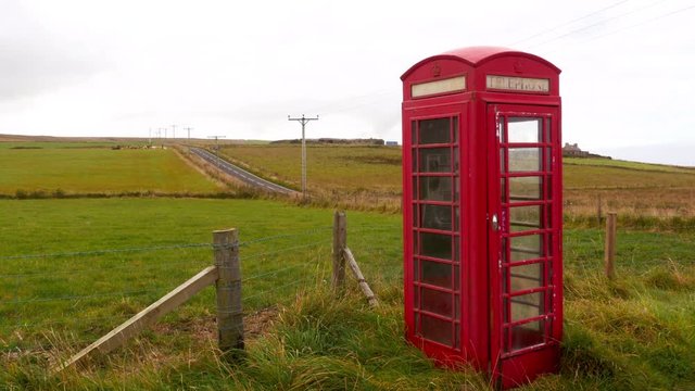 Lonely red telephone booth in a remote place in Orkney Islands