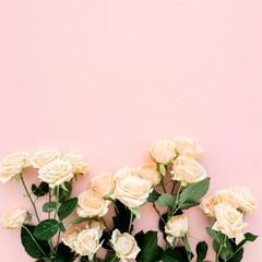 Pastel tea rose flowers on pink background. Floral background. Minimal floral concept. Flat lay, top view.  