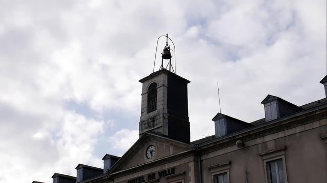 4k time lapse of the top of a french town hall on a cloudy afternoon.