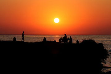 Fototapeta na wymiar Silhouette of people at sunset. Unye, Turkey