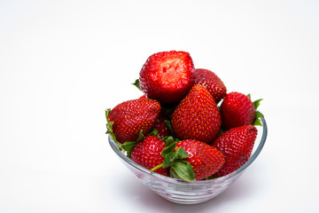 The glass bowl filled with red strawberries