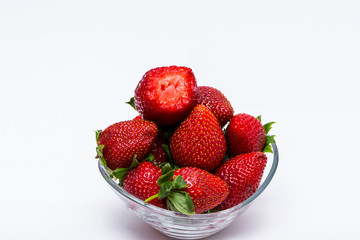 The glass bowl filled with red strawberries