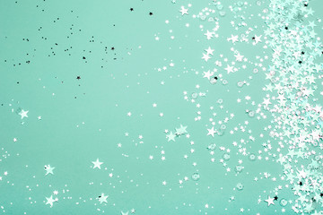 Silver and pink star glitter on teal pastel background. Festive concept. Place for design. - 239918961