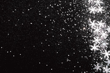 Silver snowflakes on abstract winter black background. Holiday concept. Place for text.