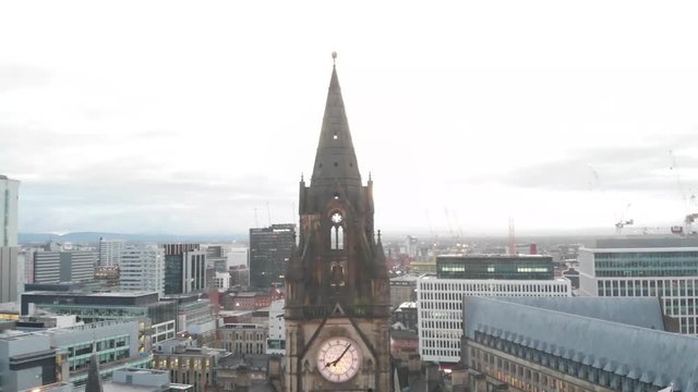 4K Drone aerial shot flying over Manchester Christmas Markets during the early cold mornings Albert Square Town Hall and above Zippy Santa Claus Statue flying downwards revealing the statue.
