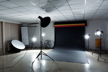 Interior of modern photo studio with professional lighting equipment