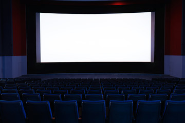 Fototapeta premium Empty cinema with large screen and comfortable chairs. Space for text