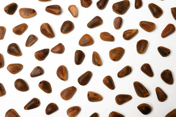 Composition with pine nuts on white background, top view