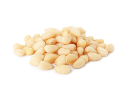 Heap of pine nuts on white background