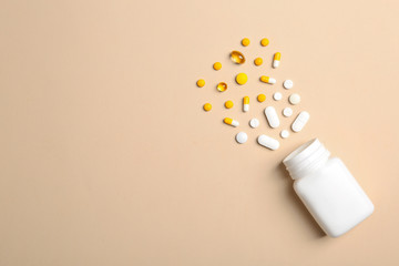 Flat lay composition with bottle, pills and space for text on color background