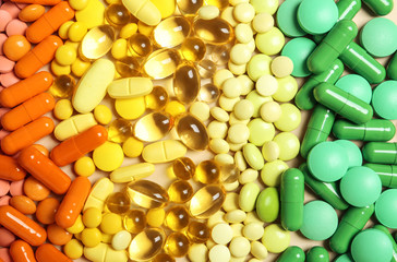 Different colorful pills as background, top view