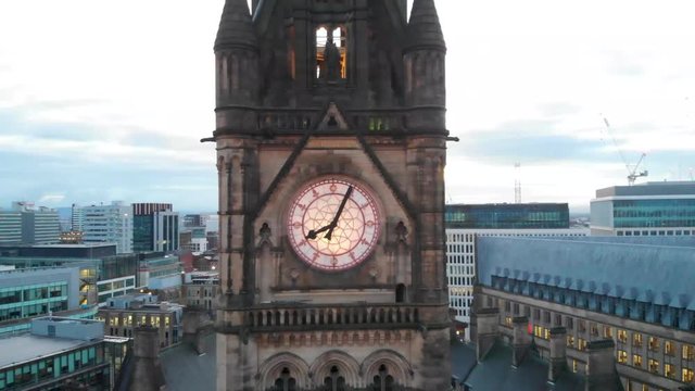 4K Drone aerial shot flying over Manchester Town Hall Albert Square Panning back from the clock tower during the early cold mornings. Shot during Manchester Christmas Market Season.