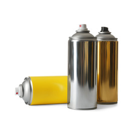 Cans of different spray paints on white background