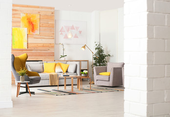 Stylish living room interior with comfortable couch and decorative elements