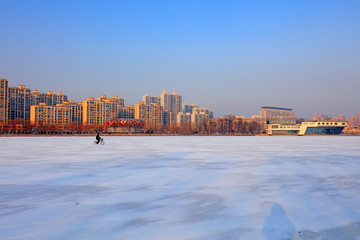 a man rides a bicycle on the river, Luannan, Hebei, China