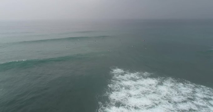 Aerial footage,Top view from drone of surfers paddling for catching waves during surfing in the indian ocean,4k