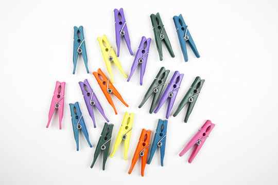 Colored clothespins for clothes on a white background