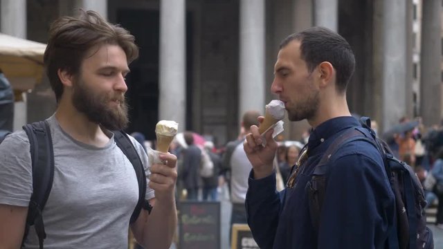 Two Friendly Backpackers Toasting With Ice Cream Cones.