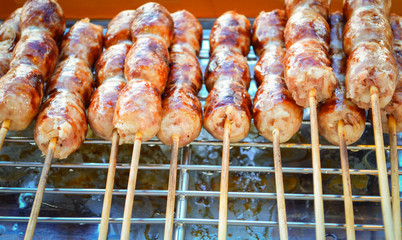 sausage grilled Thai traditional style sausage / Sai krok isan pork and rice in street food - roast sausage round - obrazy, fototapety, plakaty