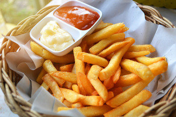French fries on basket with cream and tomato sauce french fries ketchup