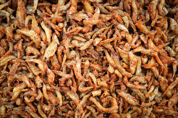 Small fried fish crispy / Pile of deep fried small fishes snack texture background in street food.