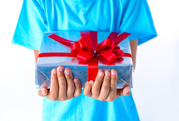 portrait of happy little asian boy holding gift boxes on white background