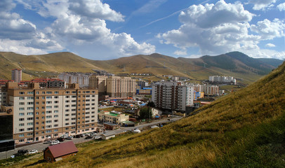 Ulan Bator, the capital of Mongolia. City panorama on mountains background. Blue sky and beautiful clouds. Asia.