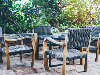 Outdoor wooden and weave armchairs near the garden