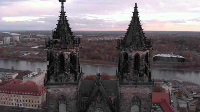 Fly through the cathedral at autumn with purple sky and a river view.
