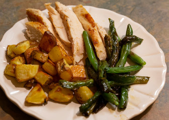 Sliced boneless skinless chicken breast with roasted potatoes and green beans