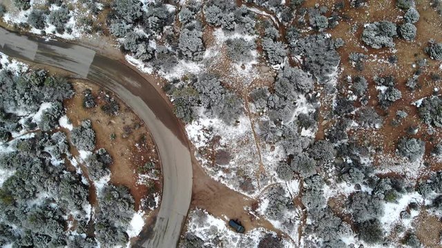 AERIAL Shot following a windy road in the mountains.