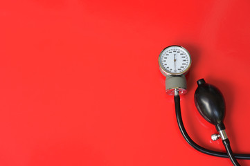 Blood pressure meter medical equipment on red background