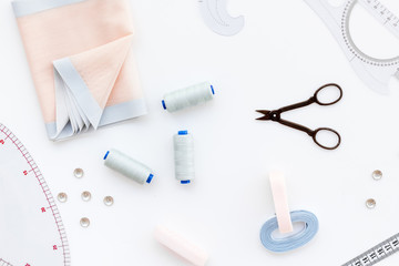 Hobby sewing with thread, scissors, fabric. Lifestyle. White background top view