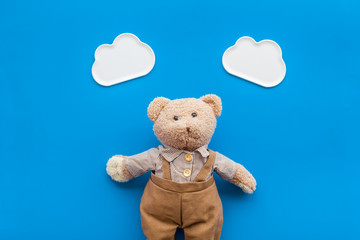 Baby care with craft toys for newborn. Teddy bear. Blue background top view