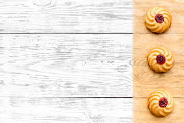 Cook homemade cookies. Pattern with fresh cookies on baking paper on white wooden background top view copy space