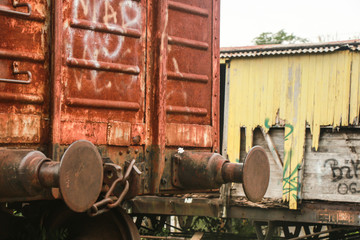 Fototapeta na wymiar Rusty orange wagon in old train station.